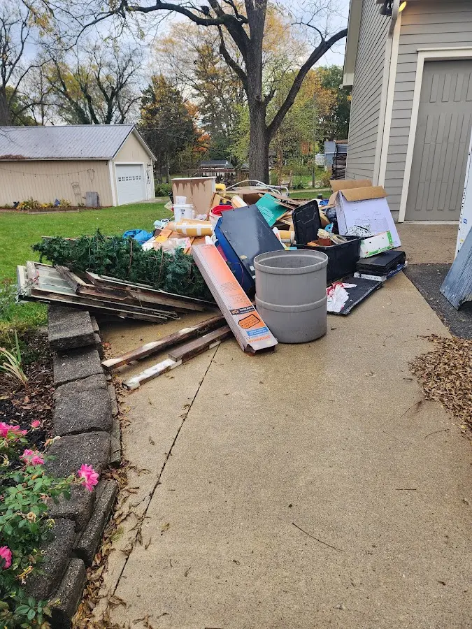 Dumpster being loaded with debris for Roofing Dumpster Rental in North Salem